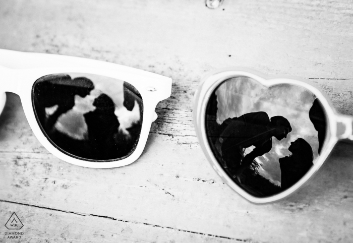 Auch, France engagement photographer of a couple reflected in two pairs of sunglasses