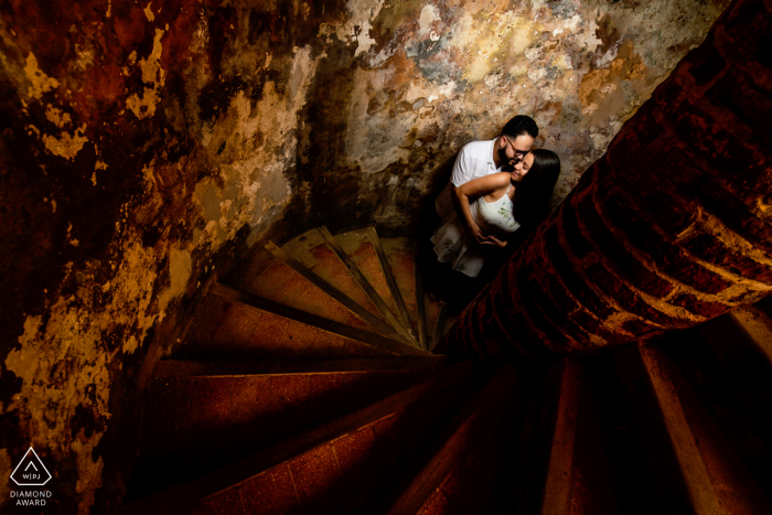 El Morro, San Juan engagement photographer: Using the ladders as a lead line towards couple. 