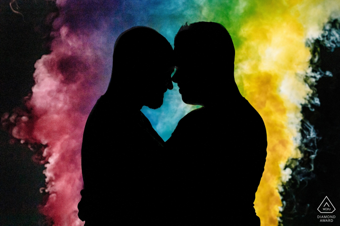 Engagement Picture Session at Baltimore, MD - Couple silhouetted against rainbow smoke bombs 