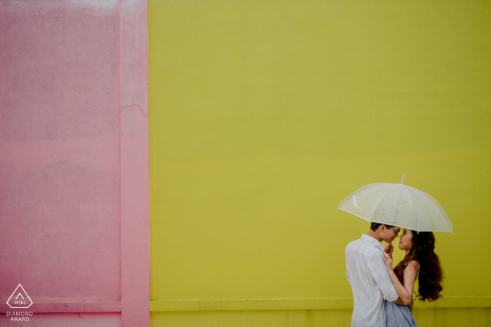 Engagement Photo Sessions | Ho Chi Minh city - They are using umbrella at a park where they have had lots of memories together 