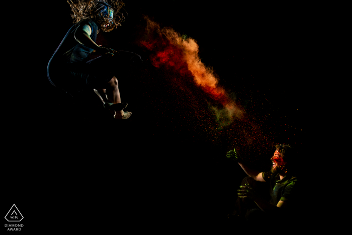 Bride and groom-to-be portraits on a trampoline with Holi powder Bride and groom-to-be on a trampoline with Holi powder