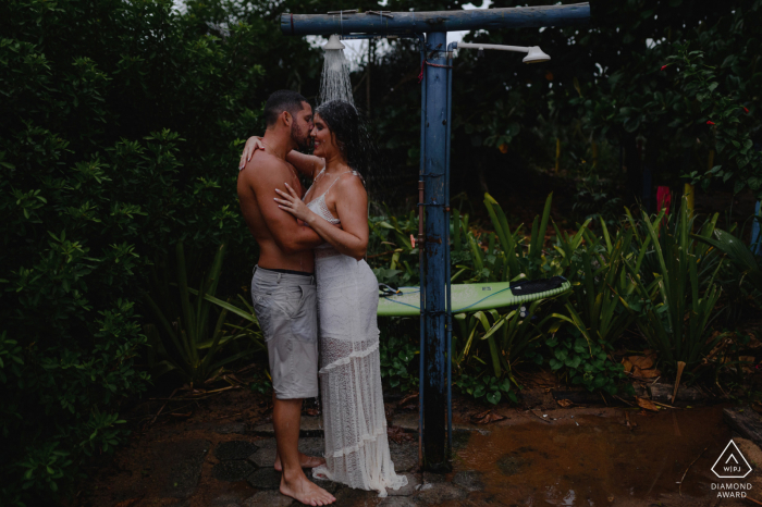 e-Session with a couple taking outdoor shower together at the beach with his surfboard Linhares, Espírito Santo, Brazil e-Session with a couple taking outdoor shower together at the beach