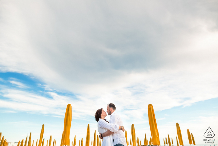 pre wedding couple portraits Among the umbrellas Grado, Italy pre wedding couple portraits | Among the umbrellas