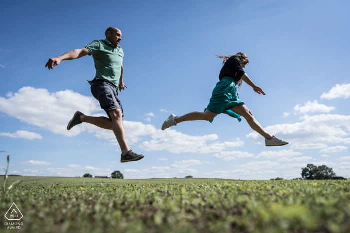 Domalain, France Couple is jumping during pre-wedding portrait session