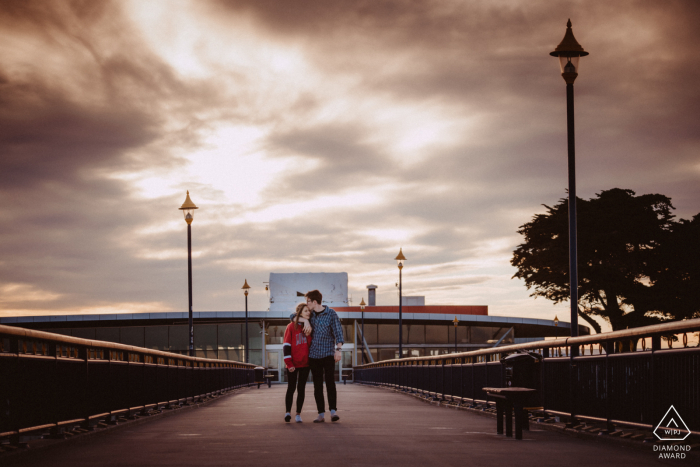 A couple walks together on the pier A couple walks together on the pier of the New Brighton Pier, Christchurch, New Zealand