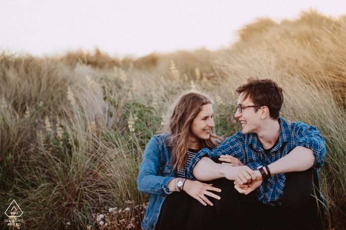 A couple sharing a humorous moment at the New Brighton Beach, Christchurch, New Zealand