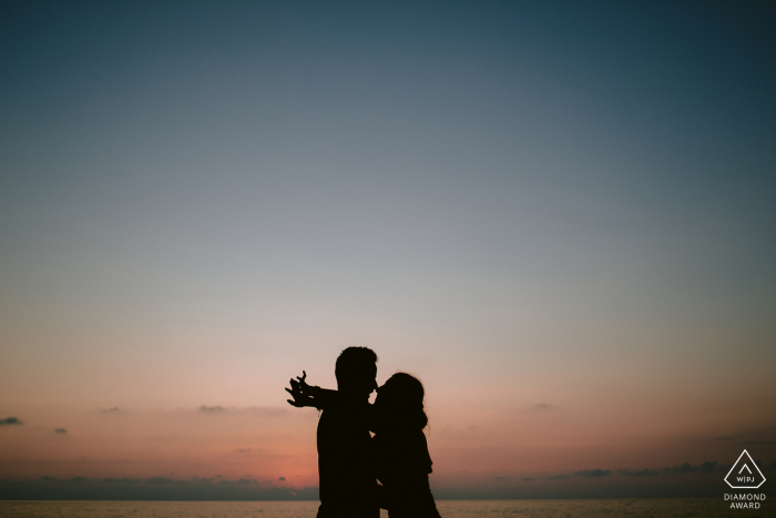 Calabria Engagement Session at sunset with a silhouetted couple against the sky