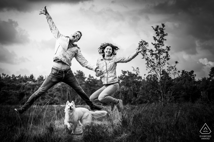 a Couple is having fun, and their dog is watching them a Couple is having fun, and their dog is watching them in Rucphense Heide in Rucphen