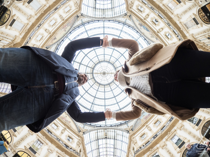 Milano, Italy low angle engagement portrait looking up at the kissing couple