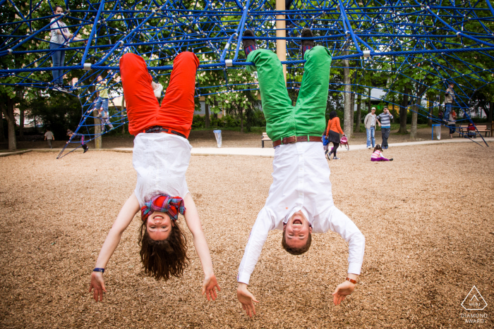 engaged couple playing on the kids playground during portrait session A couple is playing on the kids playground during portrait session in the Japanese garden at Toulouse