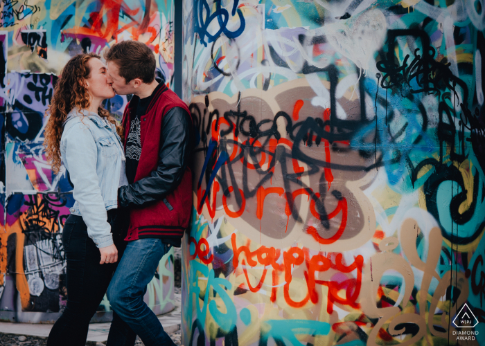 engaged Couple in front of Graffiti Wall during their portrait session New Zealand engaged Couple in front of Graffiti Wall in Christchurch City