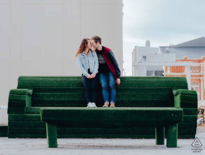 Christchurch Couple on large art installation couch in the streets of New Zealand