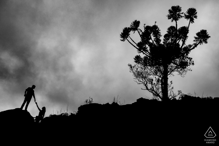 Silhouette portrait of the soon to be bride and groom in the mountain canyons Silhouette portrait of the soon to be bride and groom in the mountain canyons of cambará do sul - RS