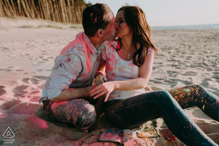 A kiss on the beach after playing with holi powder during pre-wedding photo session A kiss on the beach after playing with holi powder at Mielno