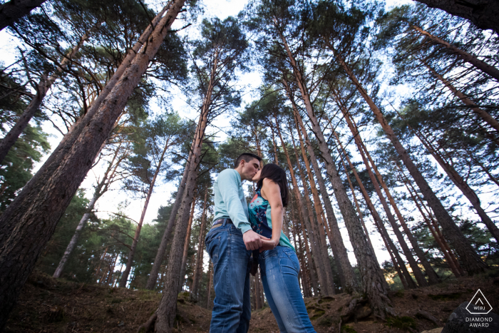 Cercedilla, Madrid (Spain) engagement shoot for couple portraits with a kiss in the middle of a forest