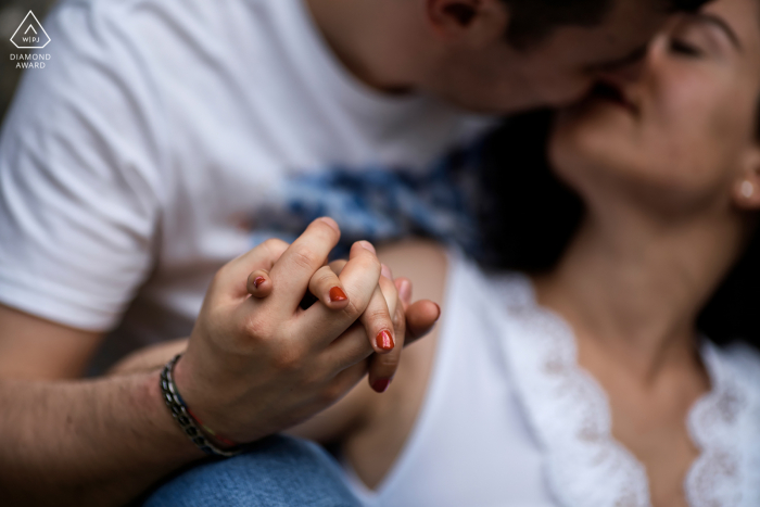 Intimate Umbria engagement photo of couple holding hands