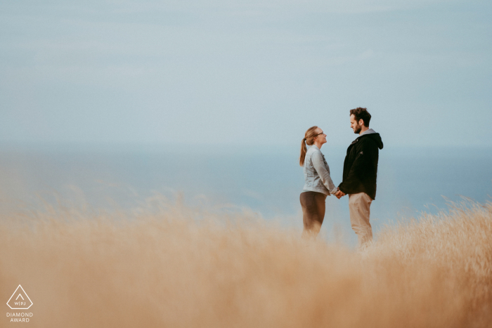 engaged Couple together by the water during their Godley Head, Christchurch NZ portrait session