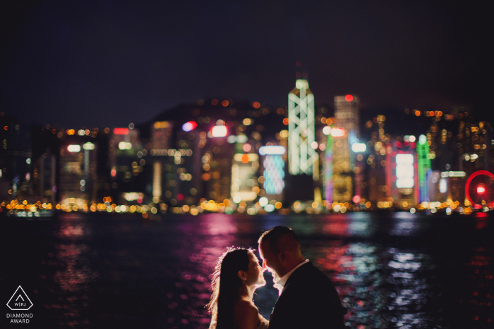 engaged Couple kissing with hong kong in the back ground for their pre-wedding portraits