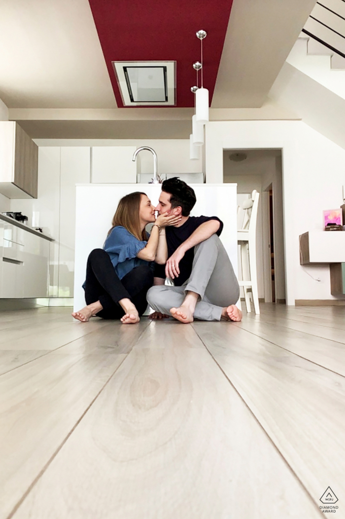 An in-home Milano, Italy facetime engagement shooting on the floor An in-home Milano, Italy facetime engagement shooting on the floor