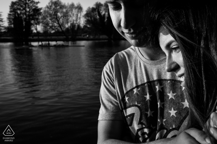 a Windsor, England (United Kingdom) sweet romantic minute for portraits at river thames during engagement shoot session a Windsor, England (United Kingdom) sweet romantic minute for portraits at river thames during engagement shoot session