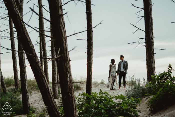 Mielno Between trees portraits for a Zachodniopomorskie engaged couple