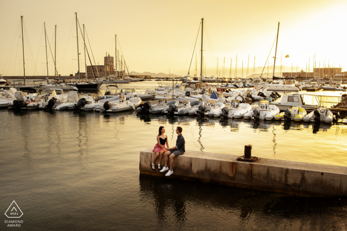 Boat marina sunset couple engagement portraits at the docks in Trapani, Italy