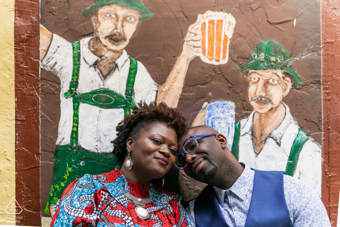 Street art engagement image from Helen, GA of couple posing with wall art Street art engagement image from Helen, GA of couple posing with wall art