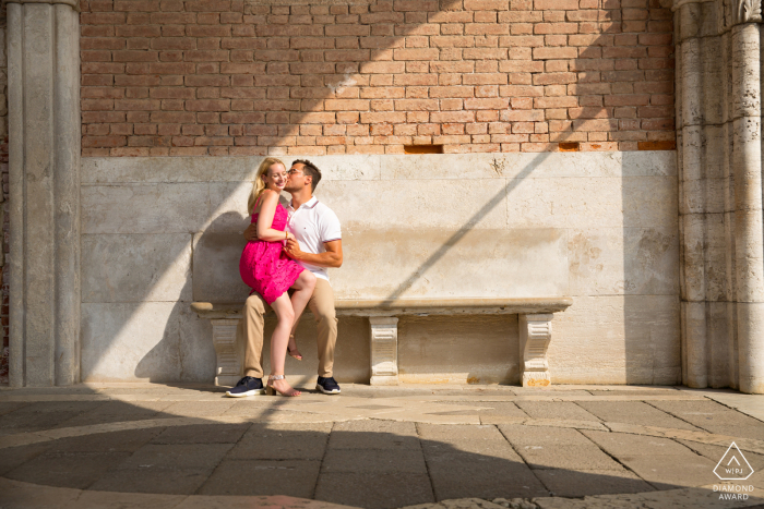 Doge Palace, St. Mark's Square, Venice Italy	Couple sitting under the Arcade in natural light with bricks