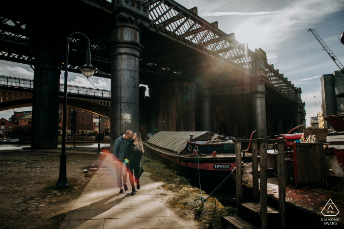 A Manchester, UK Couple kissing on a romantic walk during their engagement shoot