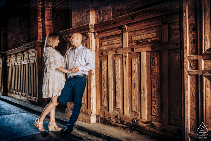 Piotrkowska Street, Lodz, Poland engagement shot of a young couple from behind the gate.