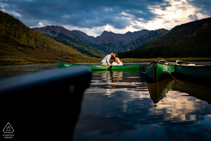 Newly engaged couple share a kiss while in a canoe on Piney Lake during their engagement session Newly engaged couple share a kiss while in a canoe on Piney Lake during their engagement session