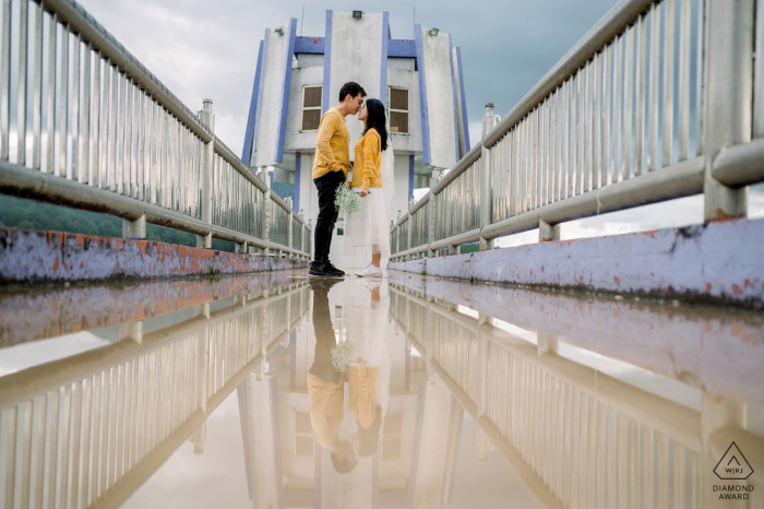 Dalat Pre Wedding portraits on the bridge with water puddle reflections