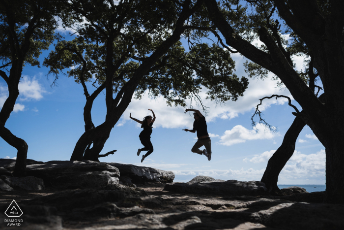 Noirmoutiers, France photography of the engaged couple jumping under the trees