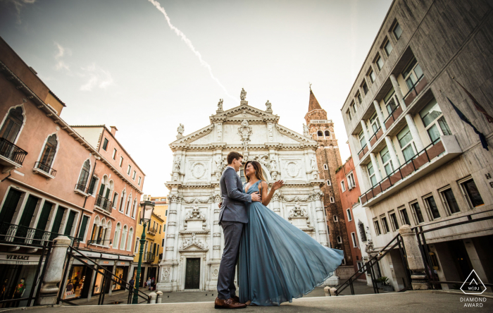 Servizio fotografico di fidanzamento in Italia da un angolo basso con una coppia vestita in modo formale a Venezia