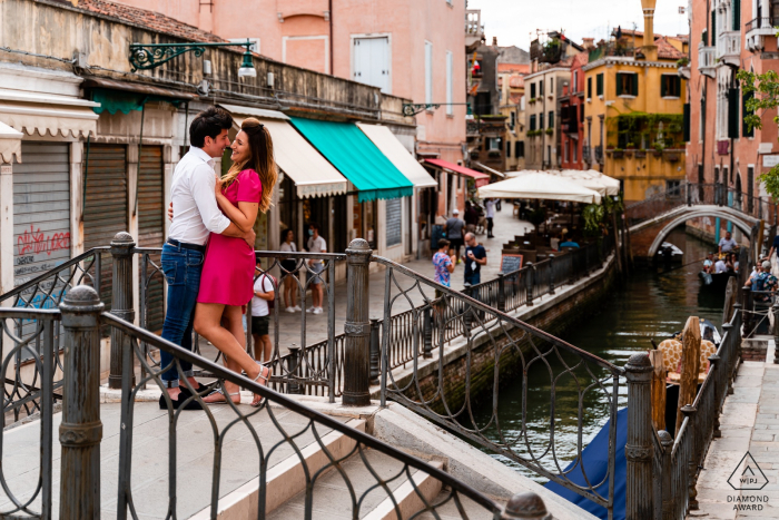 IT-Fotografie vor der Hochzeit und Verlobung, die ein Paar zeigt, das in Venedig, Italien über dem Kanal heraushängt