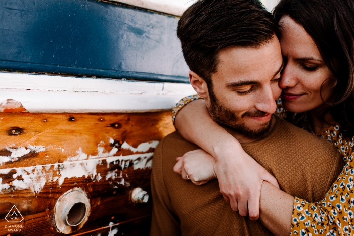 Montpellier France 	Couple embrace near a boat during a creative pre-wed session