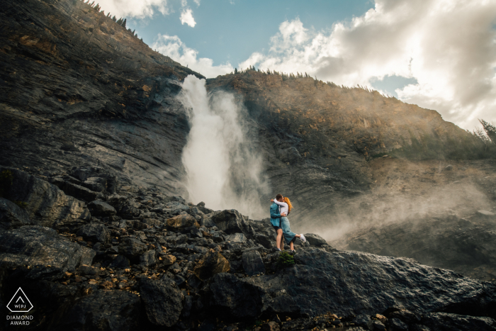 Engagement pre-wed photo shoot at Takakkaw Falls, BC, Canada with a hug at the waterfalls