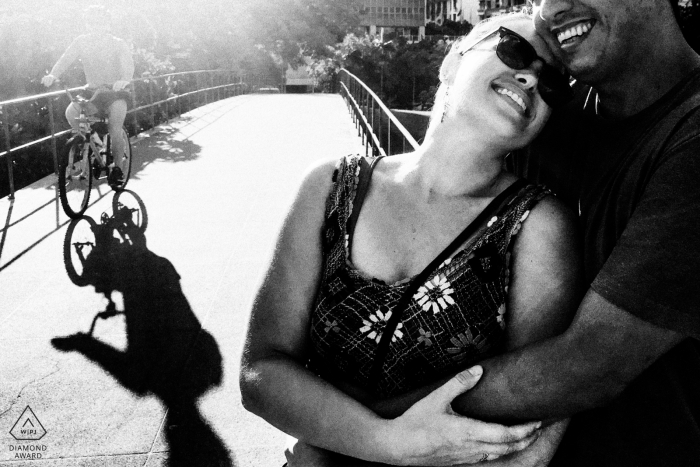 Rio de Janeiro, RJ, Brazil mini urban pic shoot before the wedding day of a couple with a cyclist going by Rio de Janeiro, RJ, Brazil mini urban pic shoot before the wedding day of a couple with a cyclist going by