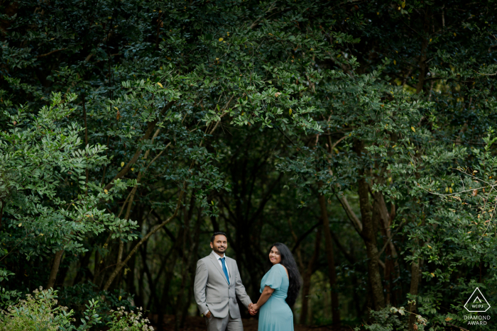 Houston Arboretum outside forest picture session before the wedding with a Couple under a lush tree awning