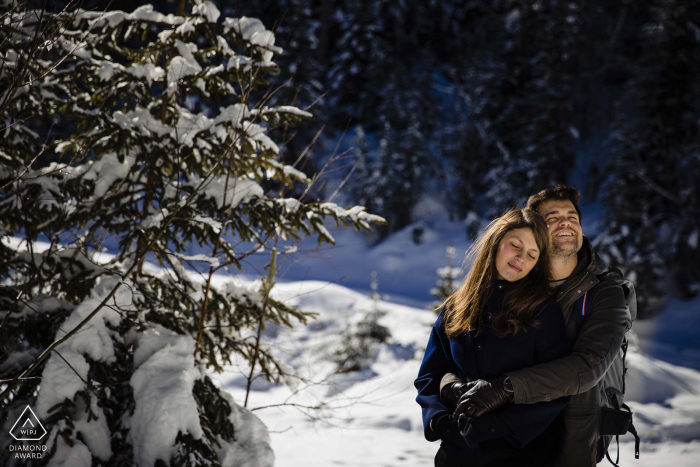 Courchevel outside forest picture session before the wedding day of a couple in a wintery forest