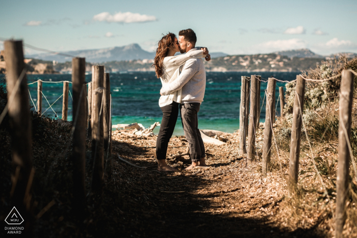 French sea mini beach photography session before the wedding day of a couple kissing on a beach French sea mini beach photography session before the wedding day of a couple kissing on a beach