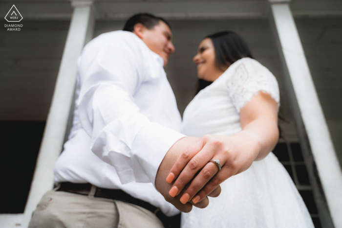 Cades Cove, Great Smoky Mountains National Park pre wedding portrait created as The couple holds hands while they show their engagement ring