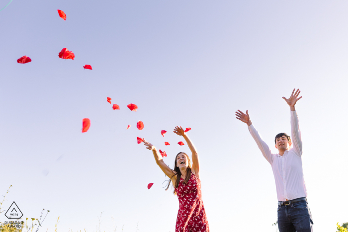 Montpellier, France outdoor portrait session under a clear sky with tossing flower petals overhead