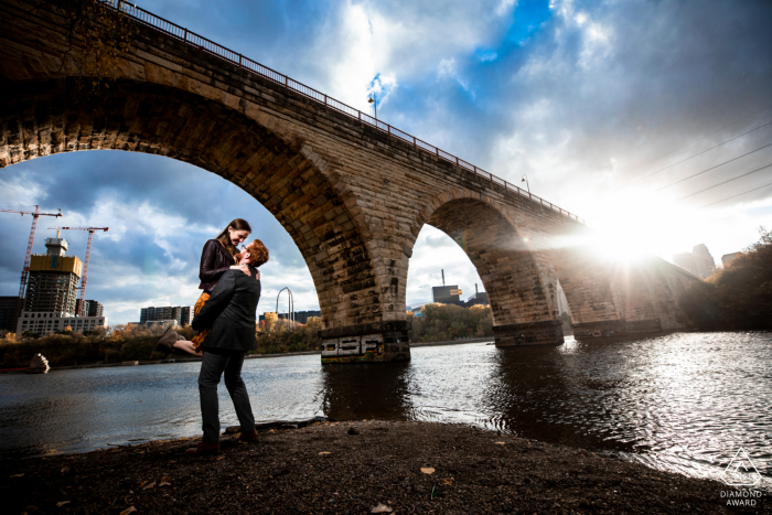 Stone Arch bridge couple portrait at the river in MN