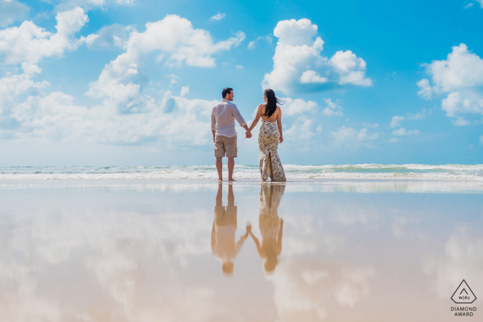 Maceió reflection couple portrait standing in the shallow waters of the ocean