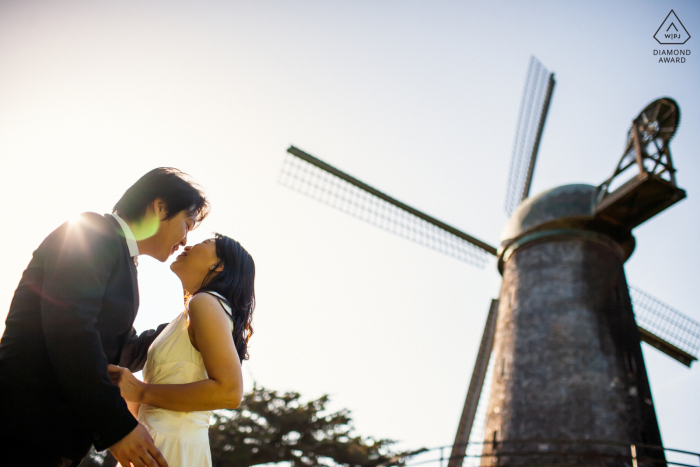 San Francisco windmill couple portrait while they kiss