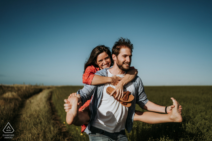 Normandie pre - wed image of a piggyback ride down a path Normandie pre - wed image of a piggyback ride down a path