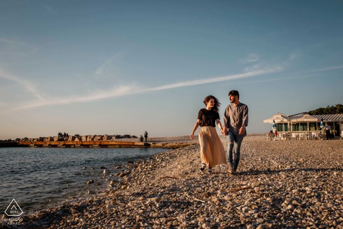 Portonovo engaged couple picture session with a carefree walk by the waters edge