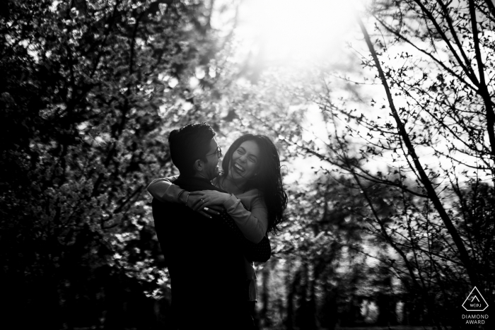 The National Arboretum Pre Wedding Photoshoot in a Fine Art Style in DC as the The couple is having fun in front of a forest of cherry trees