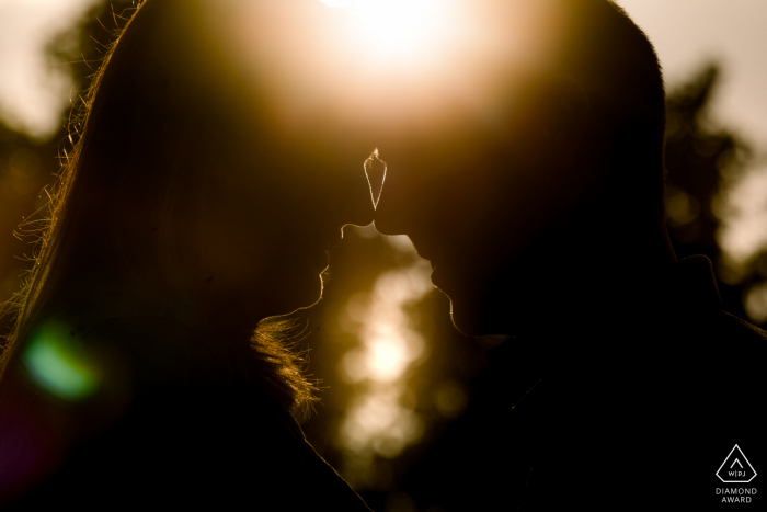 Paris Fine Art Engagement Sunset backlit shot of a couple touching heads 